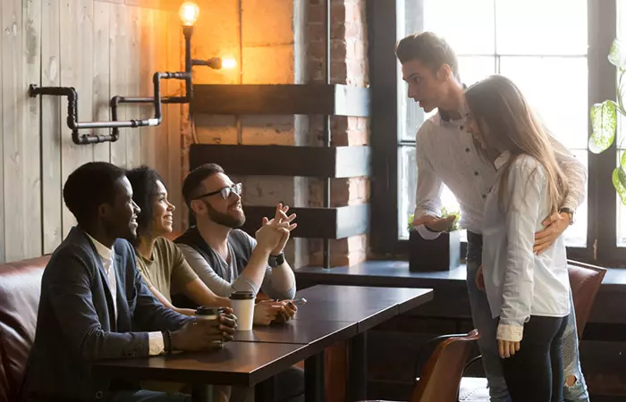 Man introducing his partner to his friends