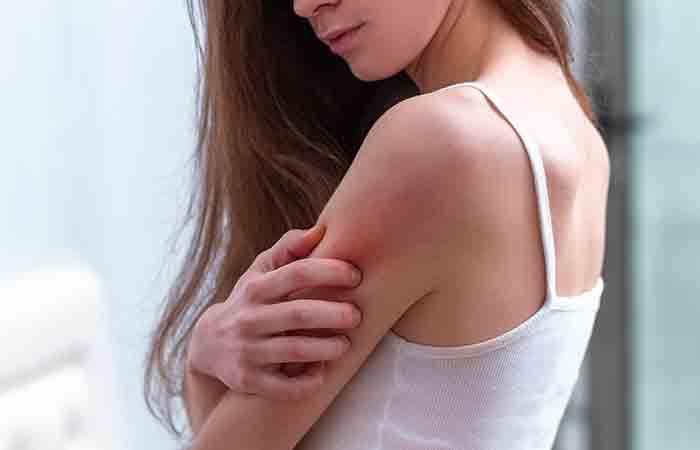 Woman examines infection on her arm may benefit from tallow for skin care