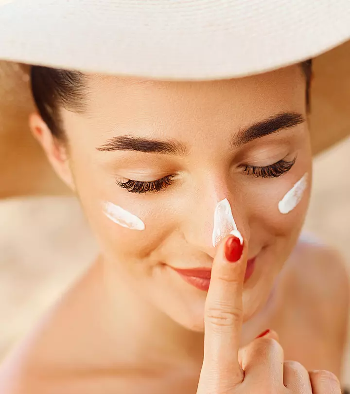 A girl applying octinoxate on her skin