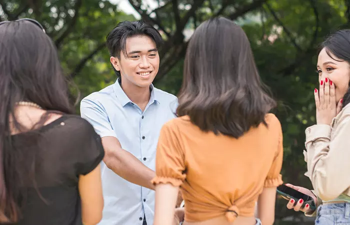 A man introducing himself to his girlfriend's friends