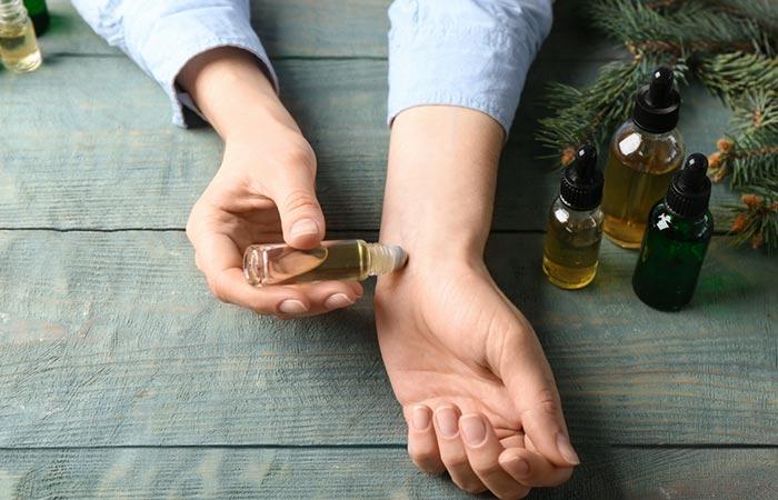 Woman doing patch test before using essential oil.