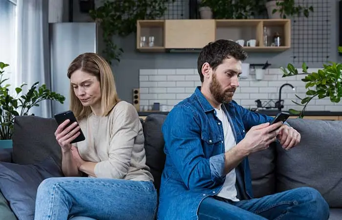 Two couples busy on their phones