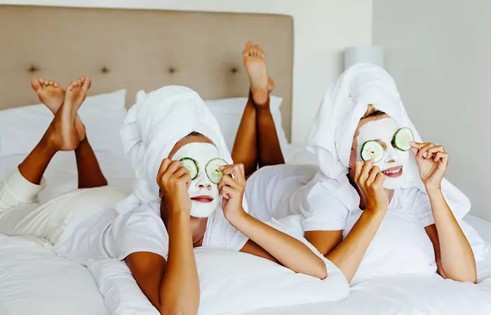 Two women applying face mask as part of skincare regimen 