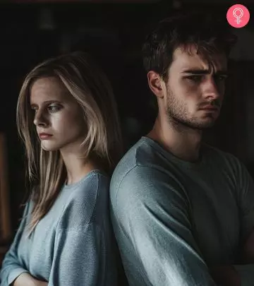 Unhappy married couple sitting on a sofa