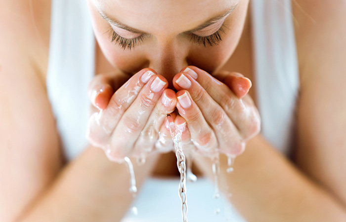 Woman washing her face with mild cleanser to avoid dry skin