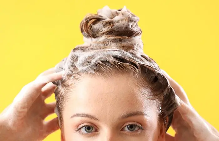 Woman washing her hair in the bathroom.