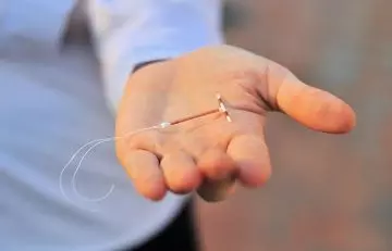 Person holding an IUD