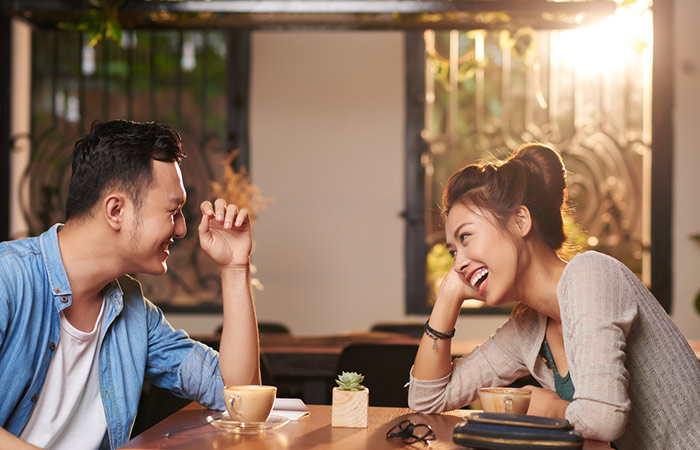 A man and a woman laughing on a date