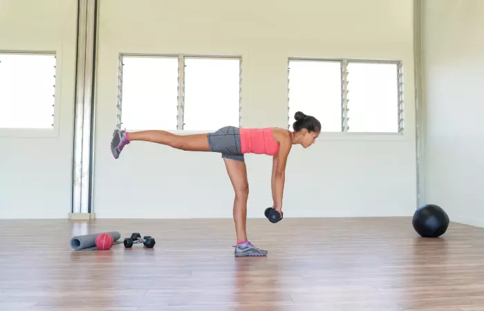 Young woman doing single-leg Romanian deadlift exercise