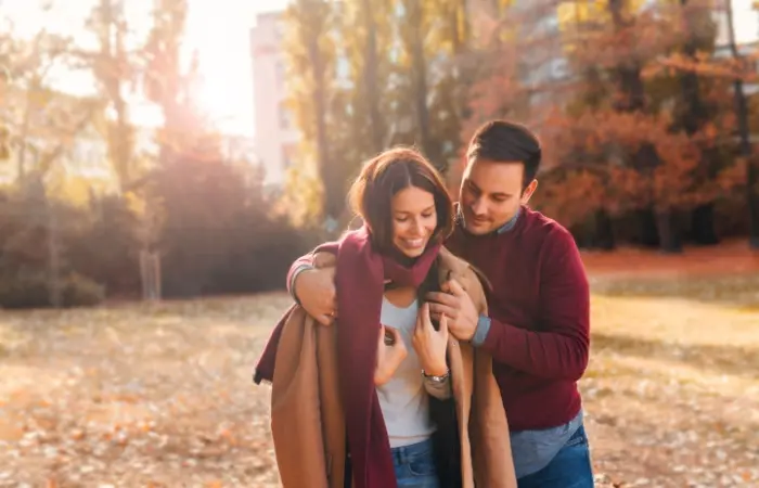 A happy couple walking in a park