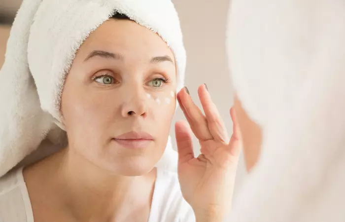 Applying eye cream on under-eye skin