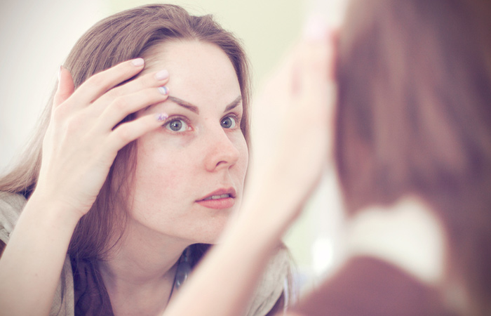 Woman checking her eyebrows for allergies