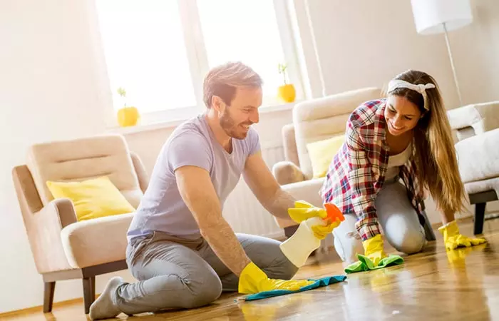 Couple having fun while doing household chores together.