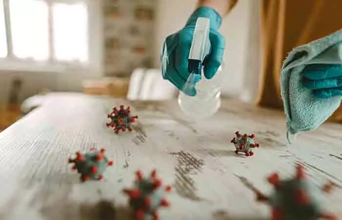 Woman disinfecting a desk with hypochlorous acid