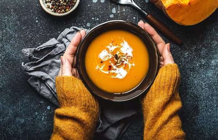 Woman eating soup with purslane seed during winter