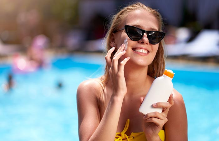 Woman applying tinted sunscreen