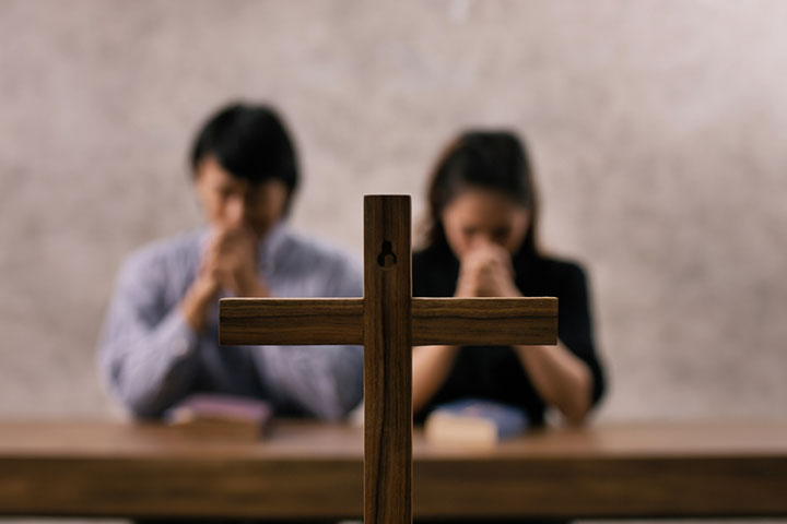 Couple praying in a church