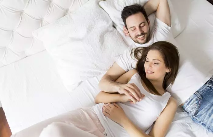 Couple relaxing in bed before making love 