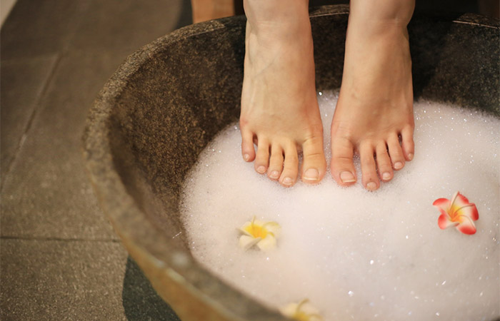 Woman cleaning her toe nails with soap water to prevent fungus