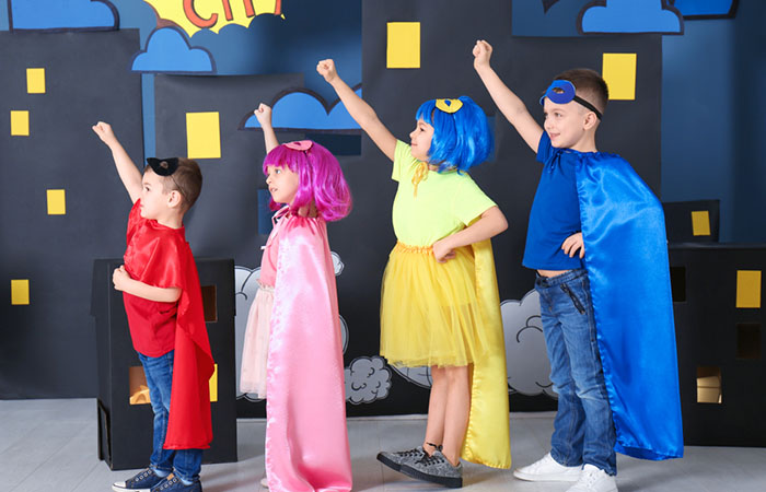 Kids celebrating during a superhero-themed party