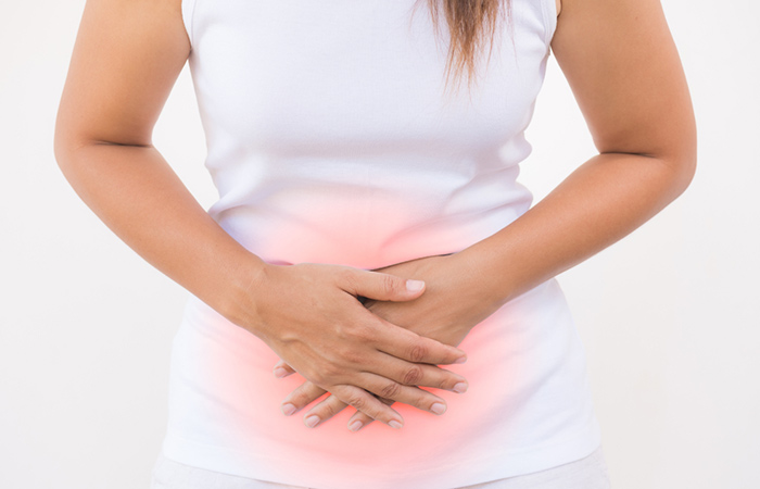 Woman with hands on the stomach to show bloating and diarrhea
