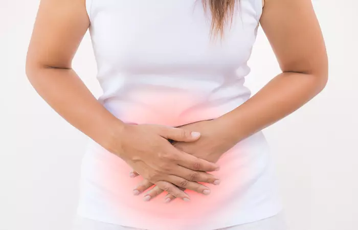 Woman with hands on the stomach to show bloating and diarrhea