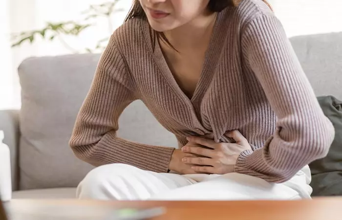 Woman experiencing flatulence as a side effect of pinto beans