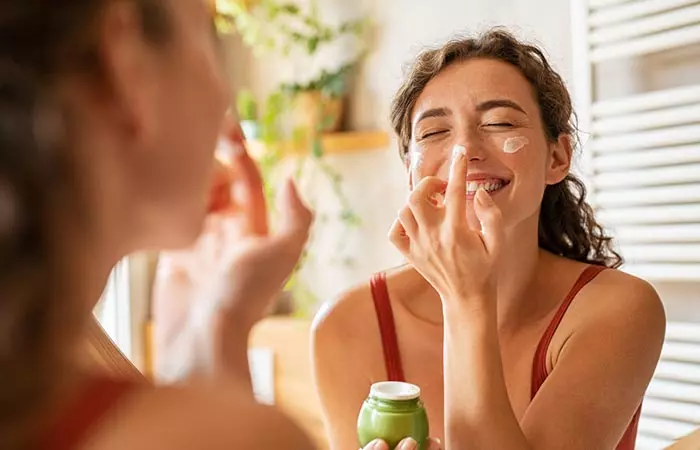 Woman applied day cream with SPF on her face