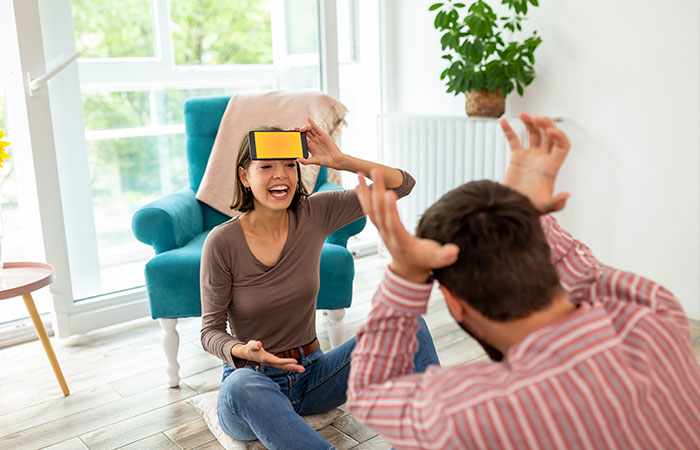 Playing charades is one of the things for couple to do at home