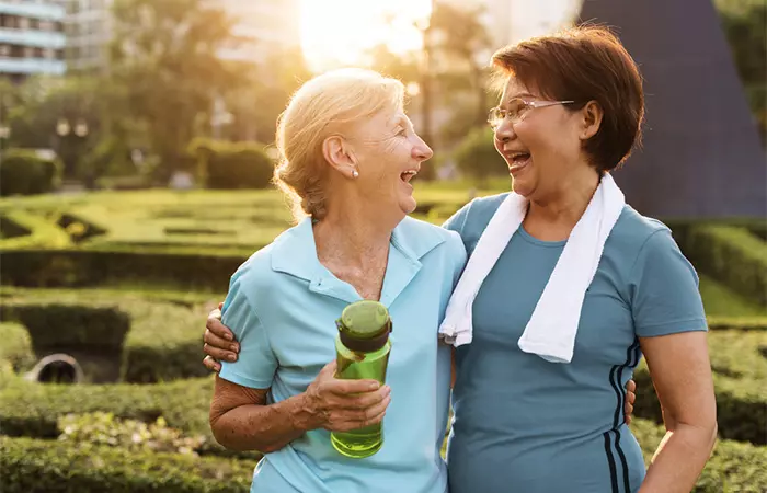 Two senior ladies share a laugh