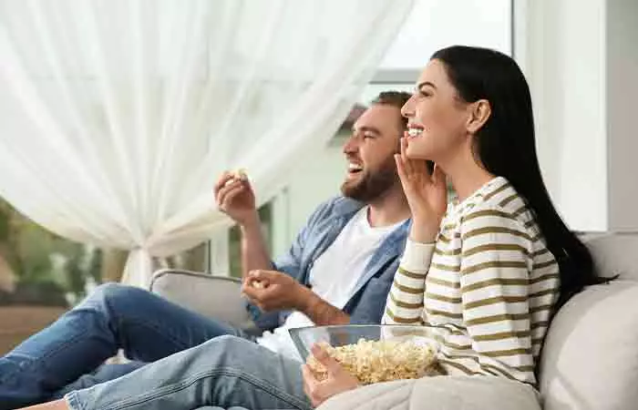 Couple enjoying a comedy movie on a rainy day