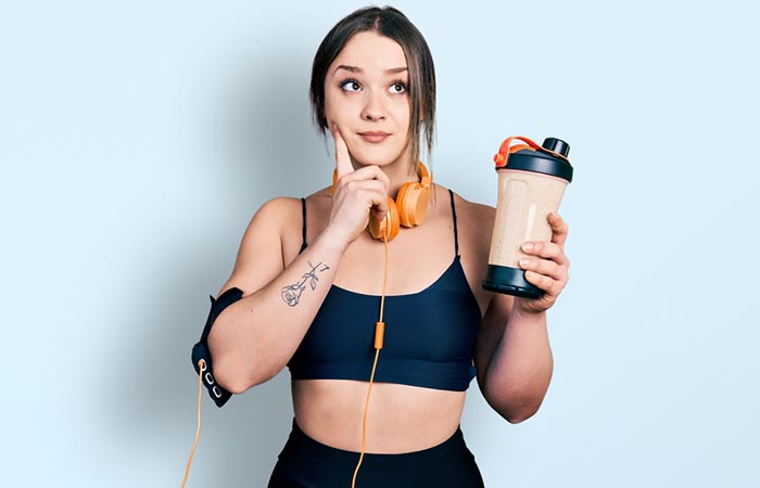 Woman thinking how often to take protein shake