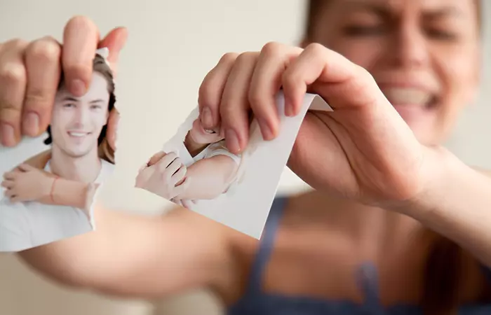 Offended woman tears photo with her boyfriend