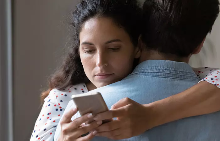 Woman chatting on mobile and cheating her husband