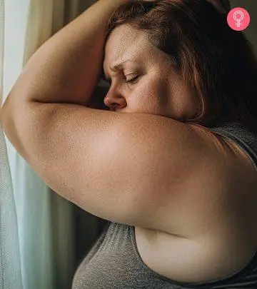 A girl showing her flabby arms