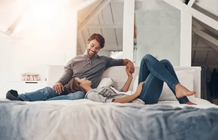 A happy couple talking in bed