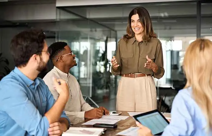 A professional Capricorn woman leading a meeting at her workplace