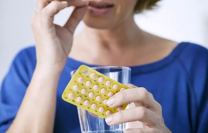 Woman taking HRT pills