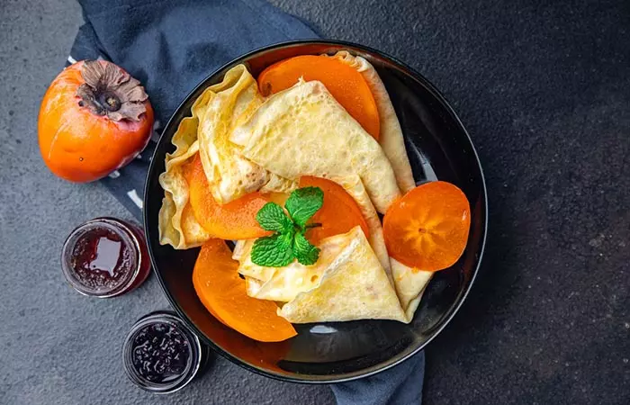 Persimmon fruit slices on pancakes