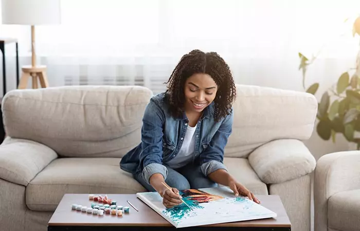 Woman painting at her home