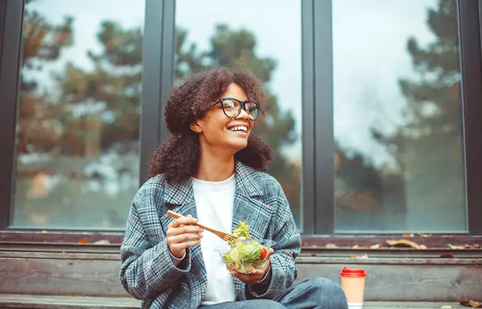 Woman having green salad to lose excess weight