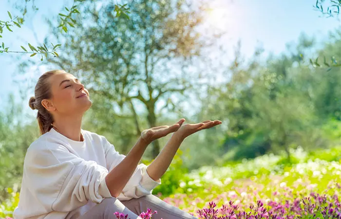 Woman relaxing at a park to minimize stress levels