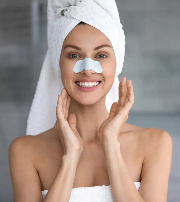 Women scrubbing her face in front of a mirror