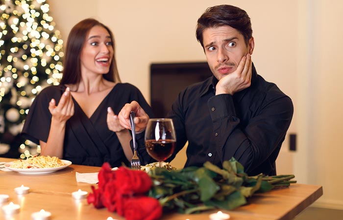 Man seems confused as his clingy girlfriend talks excitedly