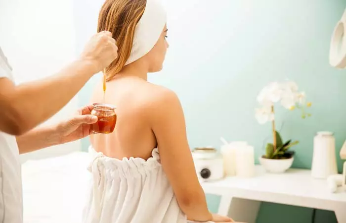 Woman brushing her long hair after using coffee for hair