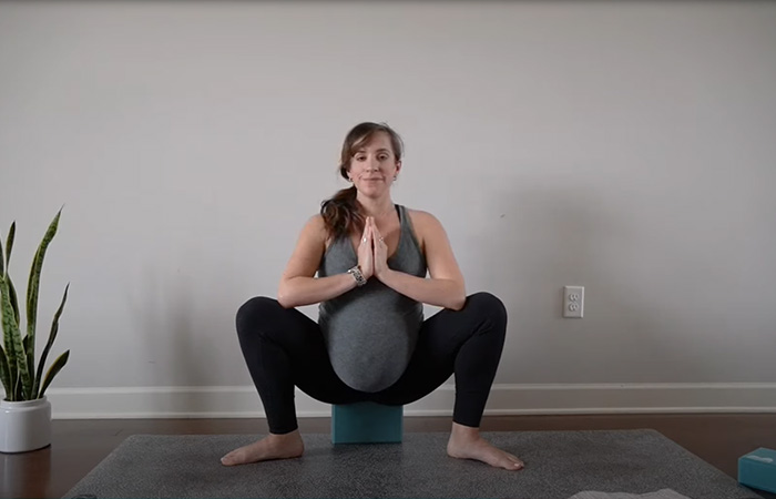 Supported deep squat or malasana exercise to induce labor