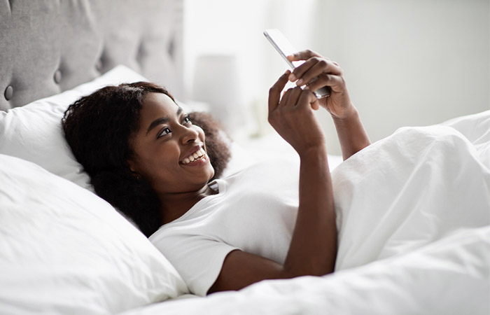 Woman checking her phone for good night messages