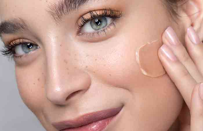 Woman applying matte foundation that contains silicones