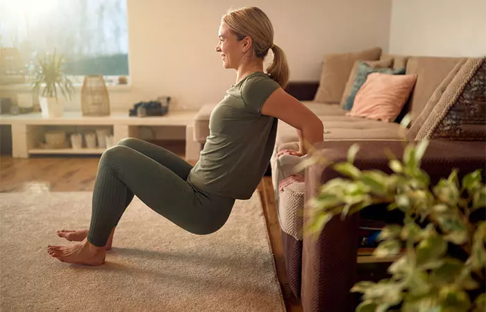 Woman doing tricep extensions at home