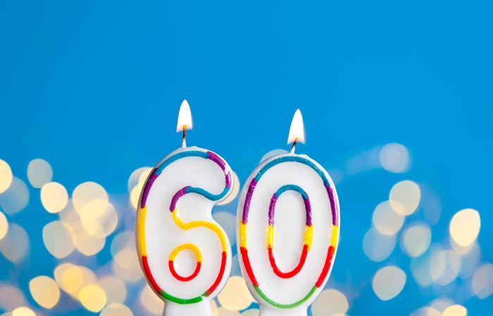number-60-birthday-celebration-candle-against